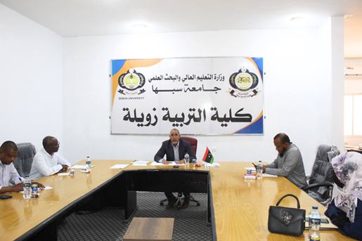 Formal university conference room scene with a central speaker at the head of a long table and attendees on both sides, an Arabic banner behind.