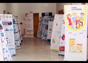 Hallway with multiple vertical informational posters on stands, showing charts and graphics.