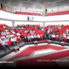 Audience seated in a large auditorium with red chairs during a formal academic conference at Sebha University in Libya.