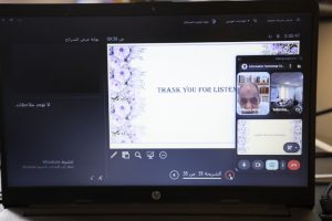 F5EF8166-BA8B-4770-9FC7-B9AE215DC116 - جامعة سبها | Sebha University Laptop screen showing a slide that reads 'THANK YOU FOR LISTEN' with a decorative border, and a small grid of participant videos on the right side of the screen.