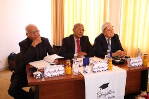 WhatsApp Image 2026-10-04 at 7.43.37 PM (1) - جامعة سبها | Sebha University Panel of three men in suits seated at a conference table with notebooks, beverages, and name placards during a formal meeting.